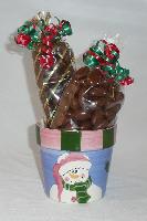 Round Snowman - A cute snowman pot filled with ½ pound of chocolate covered caramel corn and ¾ pound of chocolate covered almonds decorated with festive colored ribbons.